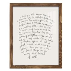 a handwritten letter is framed in a wooden frame with a white background and brown trim