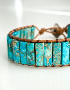 a bracelet made with turquoise stones and leather