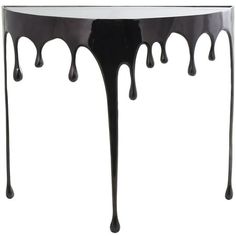 a black table with dripping paint on it