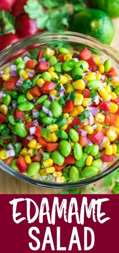 a bowl filled with colorful vegetables on top of a wooden table next to other vegetables