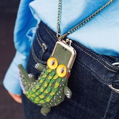 a person wearing a blue shirt holding a cell phone in their pocket