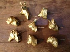 several pieces of gold colored metal sitting on top of a wooden table