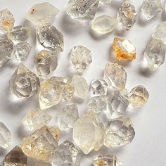 many different types of diamonds on a white surface