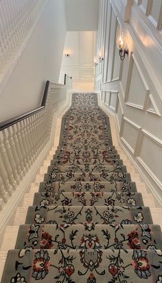 an ornate carpeted staircase leading up to the second floor