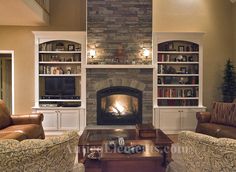 a living room filled with furniture and a fire place in the middle of a room