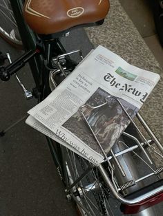 a newspaper sitting on the back of a bike