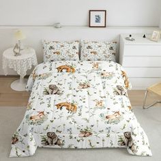 a white bed with animals on it in a room next to a table and chair