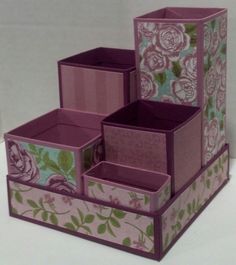 three boxes are stacked on top of each other with flowers and leaves painted on them