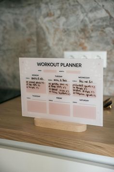 a work out planner sitting on top of a wooden table