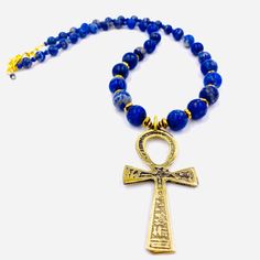 24-26 Inch Total Length 4MM - 12MM {Grade A - Natural Color} Smooth Lapis Lazuli Gemstone Gold Faceted Hematite Gemstone 3 Inch Brass Ankh Pendant Gold Plated Chain and Lobster Clasp Perfect for Men and Women. Gold Lapis Lazuli Spiritual Necklace, Traditional Gold Lapis Lazuli Jewelry, Traditional Gold Jewelry With Lapis Lazuli, Blue Ankh Jewelry Gift, Amulet Style Ankh Necklace In Brass, Blue Spiritual Necklaces For Rituals, Spiritual Blue Necklaces For Rituals, Ankh Necklace, Over The Shoulder Bags