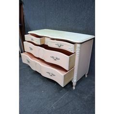 an antique dresser with three drawers is shown in this image, it has been painted pink and