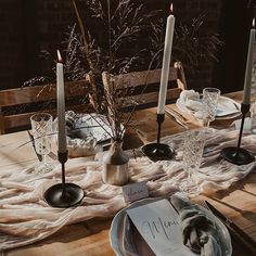 the table is set with candles and place settings