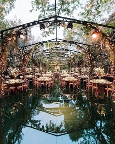 the inside of a tent with tables and chairs set up for an outdoor wedding reception