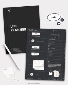 the life planner is sitting on top of a table next to a pen and paper