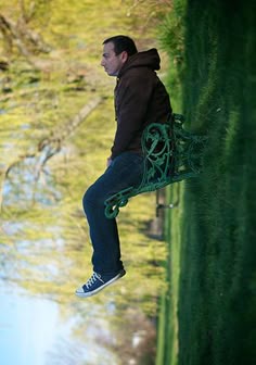 a man is sitting on a bench in front of some water and grass with the caption, maranata john main