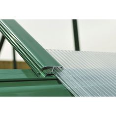 an image of a green metal roof with the bottom section missing from it's side