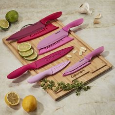 a cutting board topped with knives and lemons