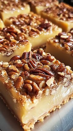 several pieces of pecan pie sitting on top of a white cutting board next to each other