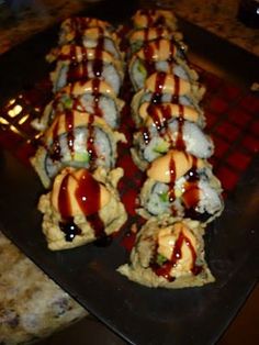 there are many sushi rolls with sauce on them