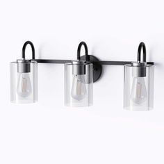 three light fixtures mounted on a wall with clear glass shades and black metal fittings