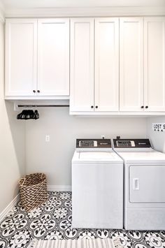 a white washer and dryer sitting next to each other in a laundry room