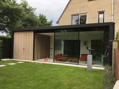 a modern house with glass walls and sliding doors