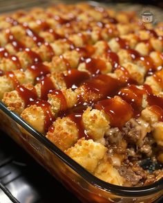 a casserole dish with meat and cheese covered in ketchup on top