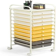 a white cart with yellow and black drawers on it's sides, holding pens and pencils