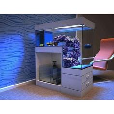 a fish tank with purple flowers in it next to a pink chair and wallpaper