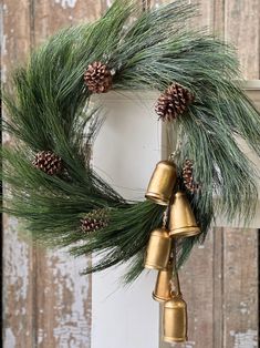 a christmas wreath with bells and pine cones