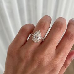 a woman's hand with a diamond ring on it