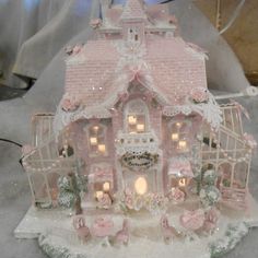 a pink doll house with lots of lights on it's roof and windows in the front