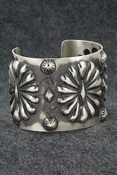 This stunning sterling silver bracelet was made by Navajo silversmith Elvira Bill. The inside is signed Elvira Bill and stamped sterling.Size: 5 7/8" (will fit up to a 7 1/4" wrist)Gap: 1 3/8"Width: 2"Free shipping on all orders! We ship with USPS and always include tracking. All orders ship within a day of payment.Returns are accepted up to 30 days after you receive your order. Just send us a message. Our shop offers cash back or store credit. The item must be returned in new condition. Southwestern Silver Bracelets With Concho, Artisan Silver Concho Cuff Bracelet, Vintage Silver Bracelets With Concho, Sterling Silver Bracelet, Sterling Silver Bracelets, Silver Bracelet, Gap, Stamp, Bracelet