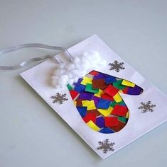 an ornament made out of colored paper with snowflakes