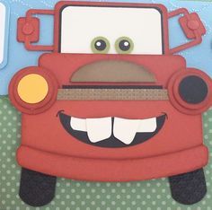 a close up of a paper cut out of a red truck with eyes and nose