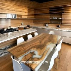 a wooden table sitting in the middle of a kitchen next to a stove top oven