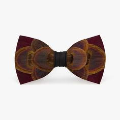 Deep, rich shades of burgundy off set the natural iridescence of the peacock eye on this beautiful bow tie. Perfect for black tie affairs, this will surely set you apart from the crowd. Elegant Brown Bow Tie For Formal Occasions, Elegant Brown Bow For Party, Brackish Bowties, Pre-tied Butterfly Knot Ties For Black Tie Events, Feather Bowtie, Elegant Brown Bow Tie, Elegant Brown Adjustable Bow Tie, Elegant Multicolor Bow Tie, Feather Bow Ties