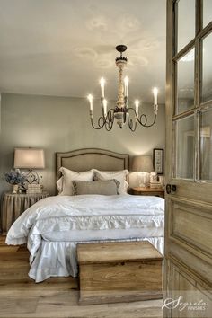 a bedroom with a chandelier and bed in it