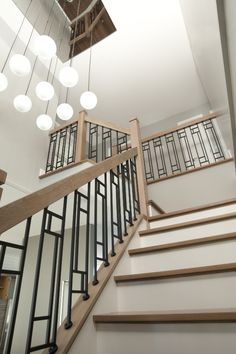 a staircase with glass balconies and wooden handrails