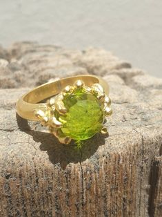 This is gold plated brass peridot ring. A designer handmade ring. It has a design of a coral, holding a green peridot gem. It could be an alternative engagement ring, or a great gift for a loving one. - 14 karat Gold plated brass - Round peridot gem - Free shipping worldwide - Sent in a gift box If you would like to see other rings I have made, please follow this link: https://www.etsy.com/il-en/shop/TamyZurTachshit?ref=seller-platform-mcnav&section_id=17271018 If you would like to go back t Handmade Elegant Peridot Rings, Elegant Handmade Peridot Rings, Handmade Peridot Ring For May Birthstone, Unique Green Peridot Rings, Handmade Peridot Wedding Rings, Unique Green Brass Ring, Unique Green Brass Rings, Handmade Green Brass Rings, Gold Peridot Ring