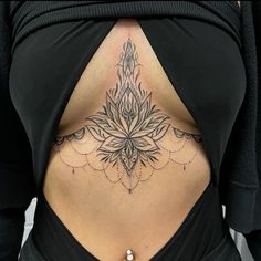 a woman's lower back tattoo with an intricate design