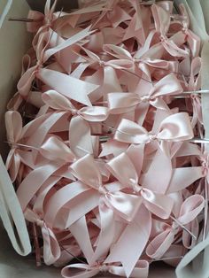 a box filled with lots of pink ribbon