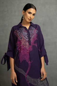 Purple shirt tunic with abstract floral digital print, highlighted with sequin, bead and thread embroidery and knot sleeves. Paired with a pant. - Aza Fashions Purple Straight Kurta With Printed Motifs, Festive Blouse With Printed Motifs For Eid, Designer Wear Blouse With Printed Motifs, Festive Tunic Kurta With Embroidered Sleeves, Designer Wear Blouse With Printed Motifs For Navratri, Festive Embroidered Sleeve Tunic Kurta, Navratri Designer Blouse With Printed Motifs, Navratri Blouse With Printed Motifs, Traditional Straight Kurta Top With Embroidery