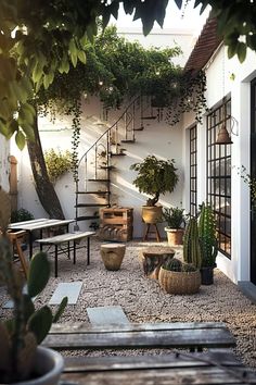 an outdoor patio with potted plants and stairs