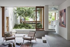 an open living room with two chairs and a coffee table