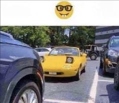 there are many cars in the parking lot and one has a smiley face on it