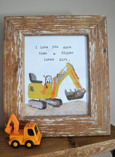 a wooden frame with a construction scene and a toy truck in front of it that says i love you more than a digger loves dirt