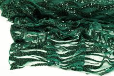 Emerald green beads and sequins on an emerald green tulle. Green Glamorous Sequin Fabric For Festive Occasions, Green Sequin Fabric For Wedding, Green Sequin Wedding Fabric, Glamorous Green Sequin Fabric For Festive Occasions, Glamorous Green Sequin Fabric, Elegant Green Sequin Fabric, Glamorous Fitted Green Sequin Fabric, Embellished Green Glamorous Sequin Fabric, Embellished Green Sequin Fabric