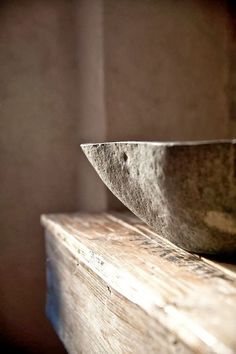 a bowl sitting on top of a wooden shelf