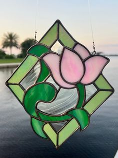 a stained glass flower hanging from the side of a boat